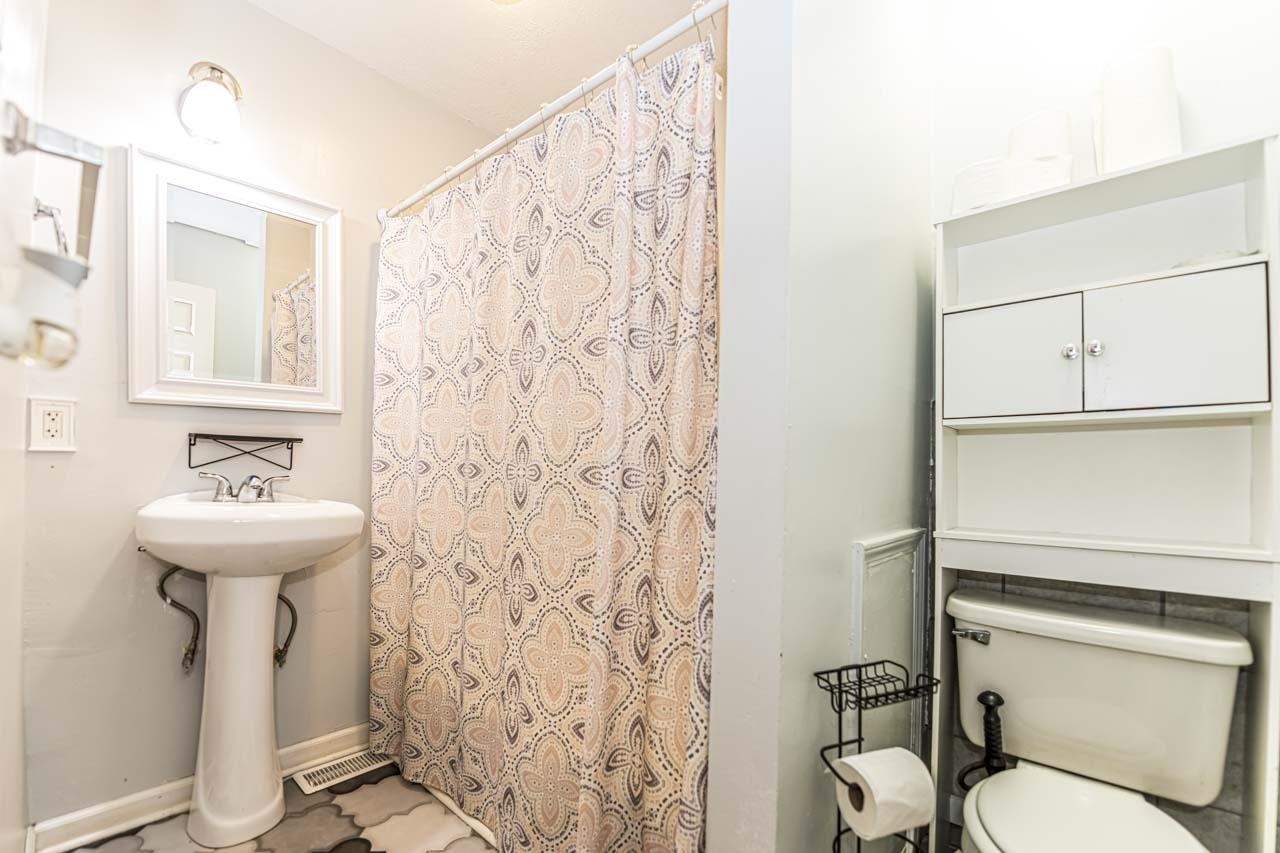 827 Sanford Road Covington, TN 38019 - Photo 11 of 25 a bathroom with a sink toilet and shower