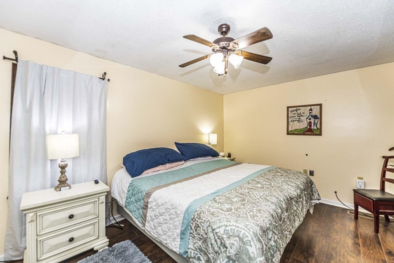827 Sanford Road Covington, TN 38019 - Photo 13 of 25 a bedroom with a bed and a chandelier