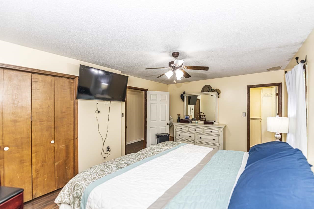 827 Sanford Road Covington, TN 38019 - Photo 14 of 25 a bedroom with a bed and a chandelier