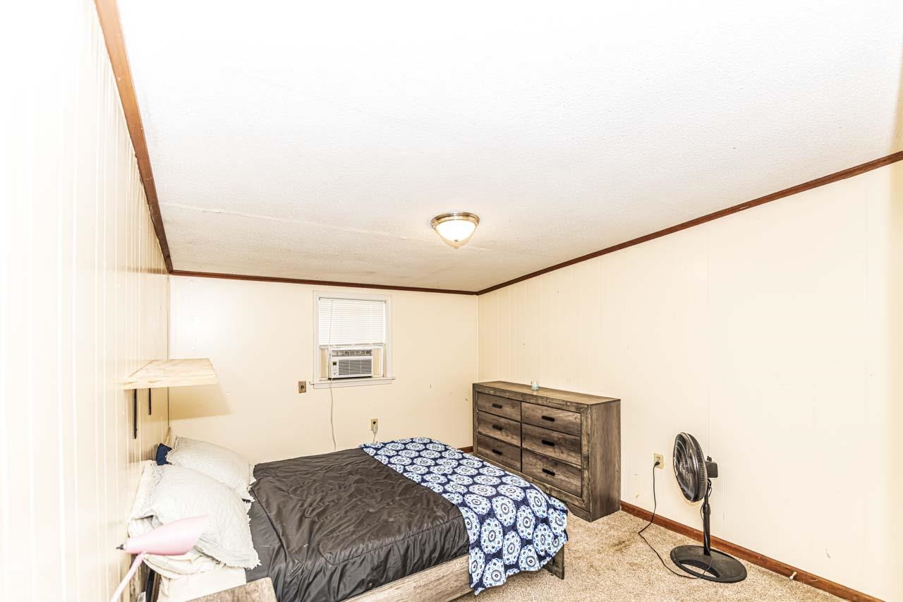 827 Sanford Road Covington, TN 38019 - Photo 16 of 25 a bedroom with a bed and a table