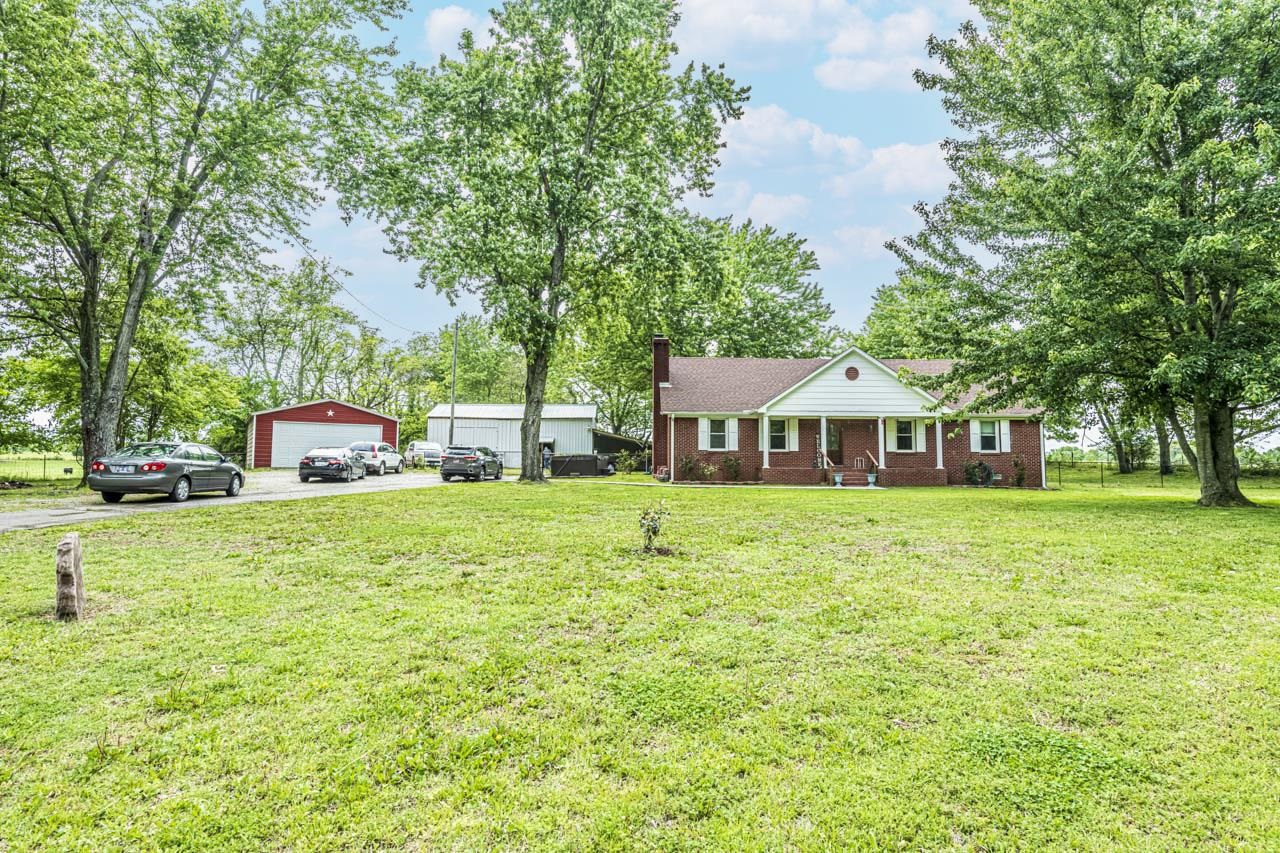 827 Sanford Road Covington, TN 38019 - Photo 19 of 25 a front view of a house with a garden