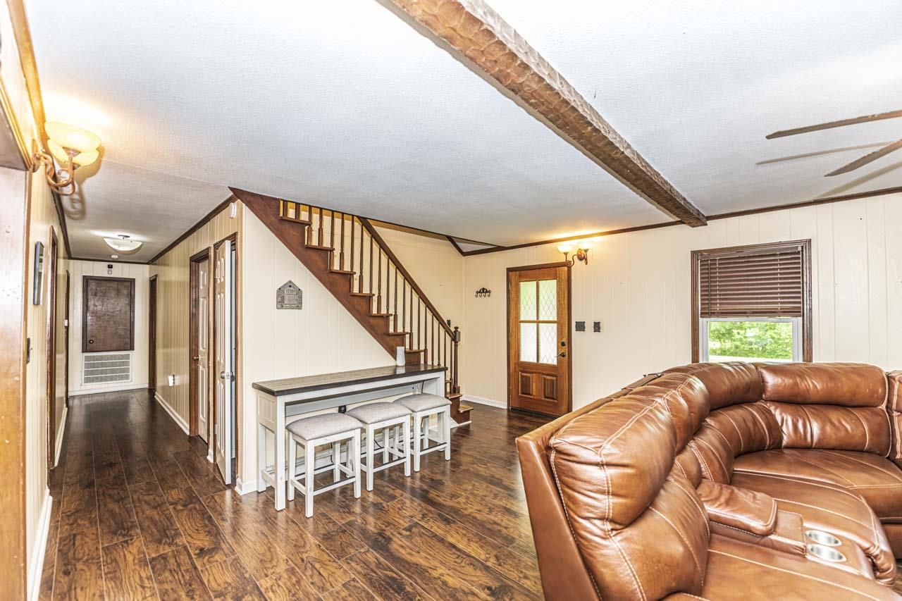 827 Sanford Road Covington, TN 38019 - Photo 2 of 25 a living room with furniture or stairs and a wooden floor