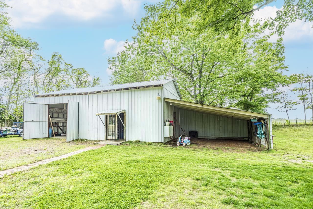 827 Sanford Road Covington, TN 38019 - Photo 22 of 25 a view of a backyard with a garden