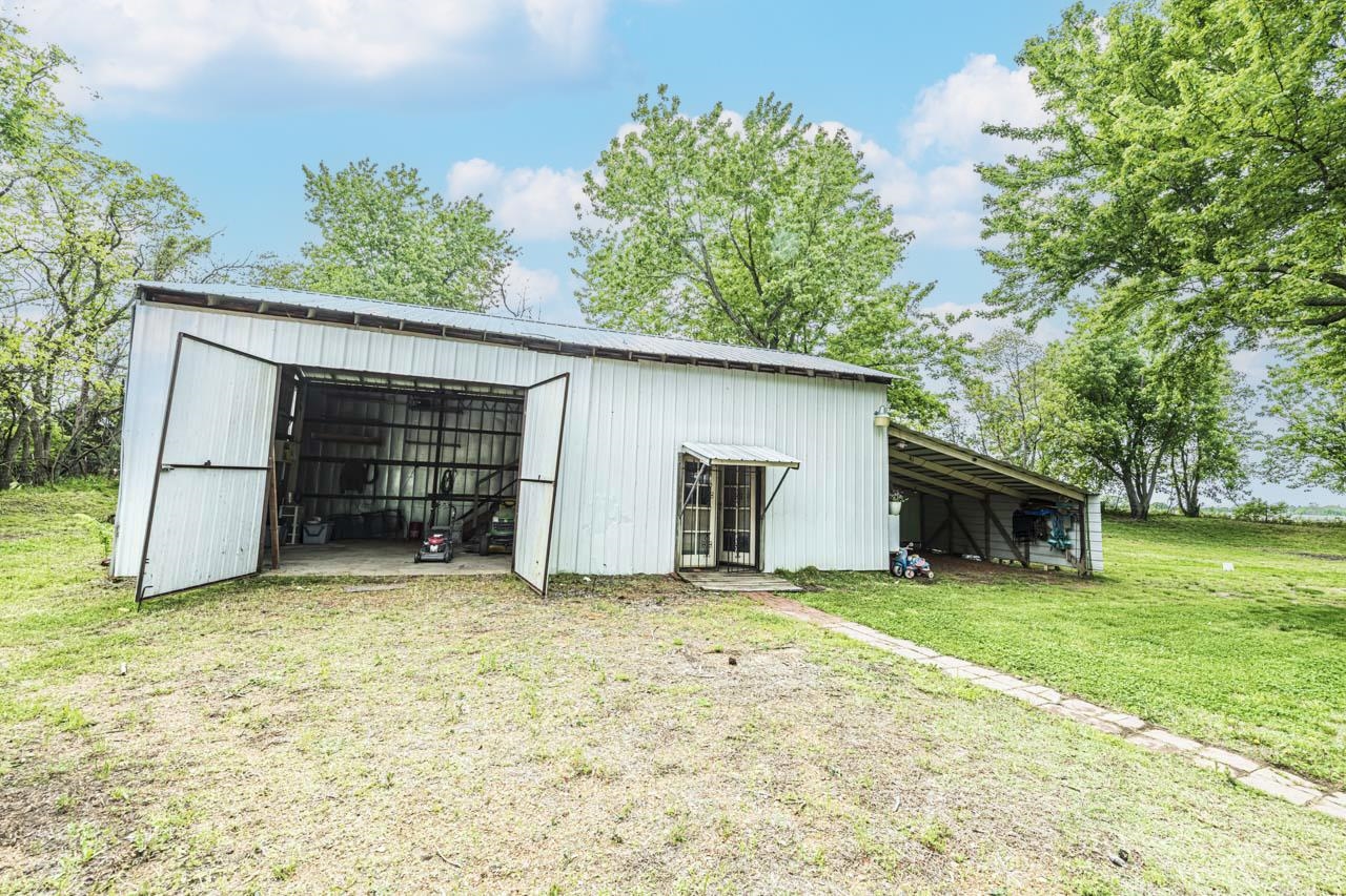 827 Sanford Road Covington, TN 38019 - Photo 23 of 25 a view of a house with a yard and garage
