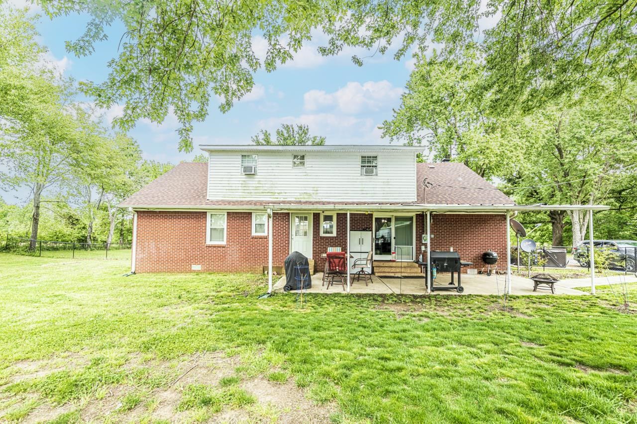 827 Sanford Road Covington, TN 38019 - Photo 25 of 25 a front view of house with yard and trees in the background