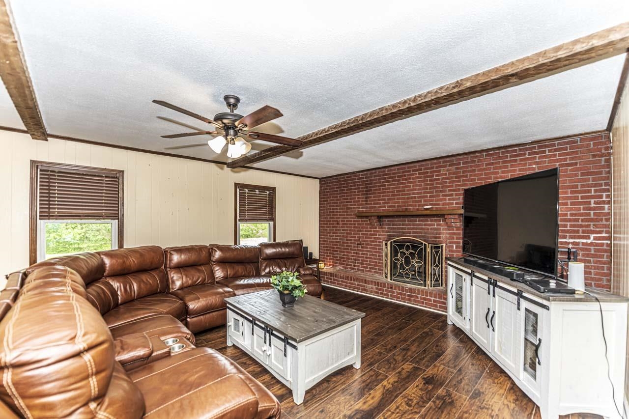 827 Sanford Road Covington, TN 38019 - Photo 4 of 25 a living room with furniture a flat screen tv and a fireplace