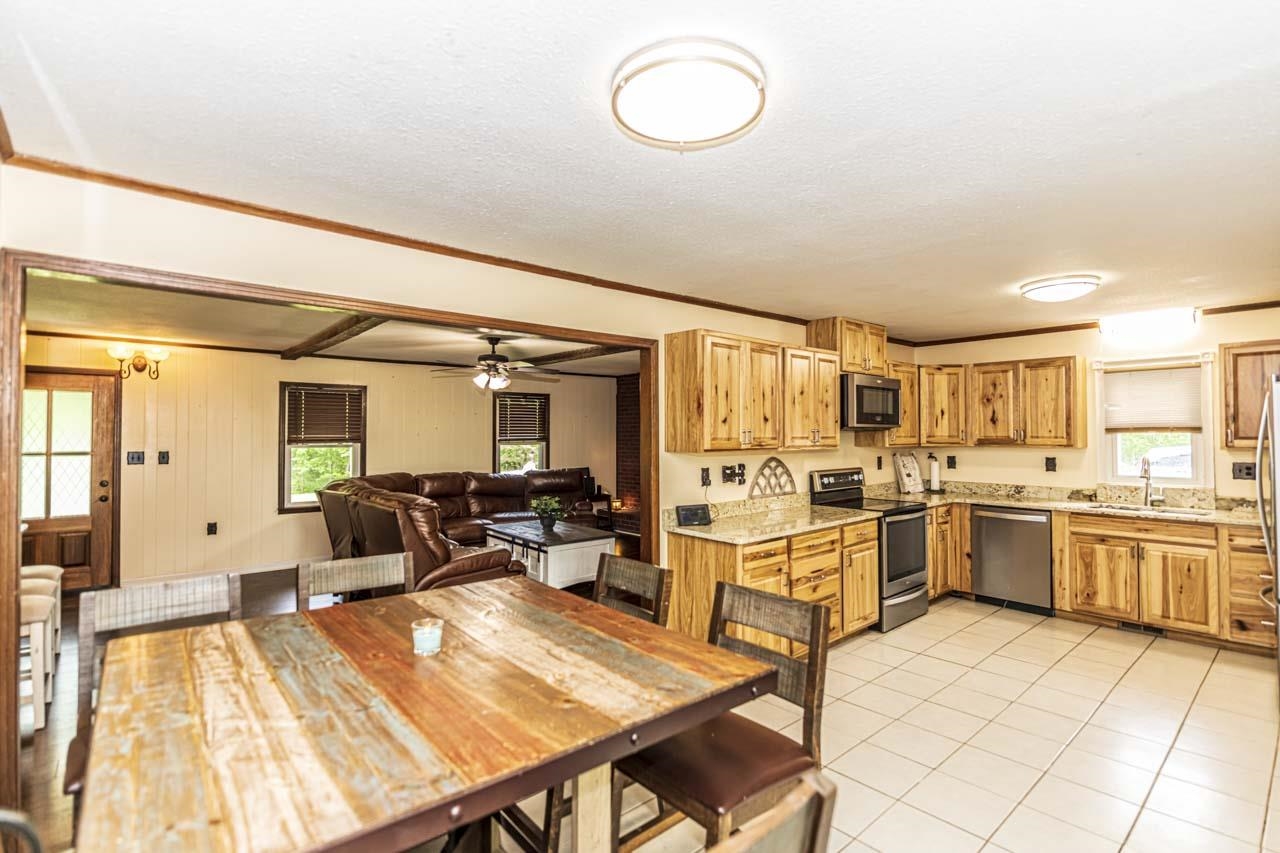 827 Sanford Road Covington, TN 38019 - Photo 5 of 25 a large white kitchen with cabinets