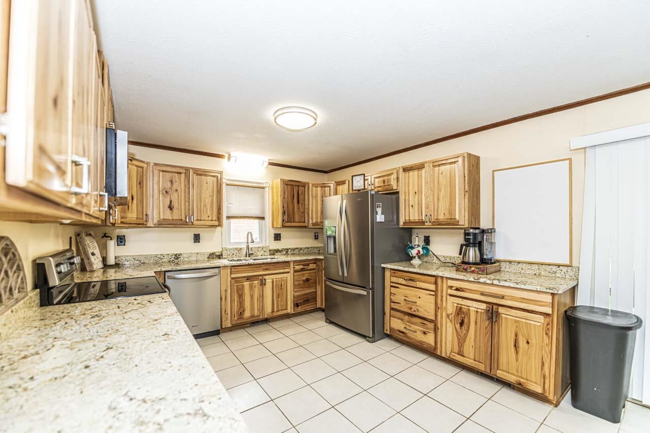 827 Sanford Road Covington, TN 38019 - Photo 8 of 25 a kitchen with a stove sink and cabinets