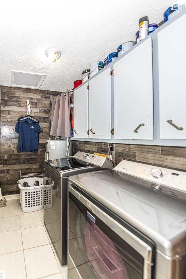 827 Sanford Road Covington, TN 38019 - Photo 9 of 25 a kitchen with blue cabinets a sink and a stove