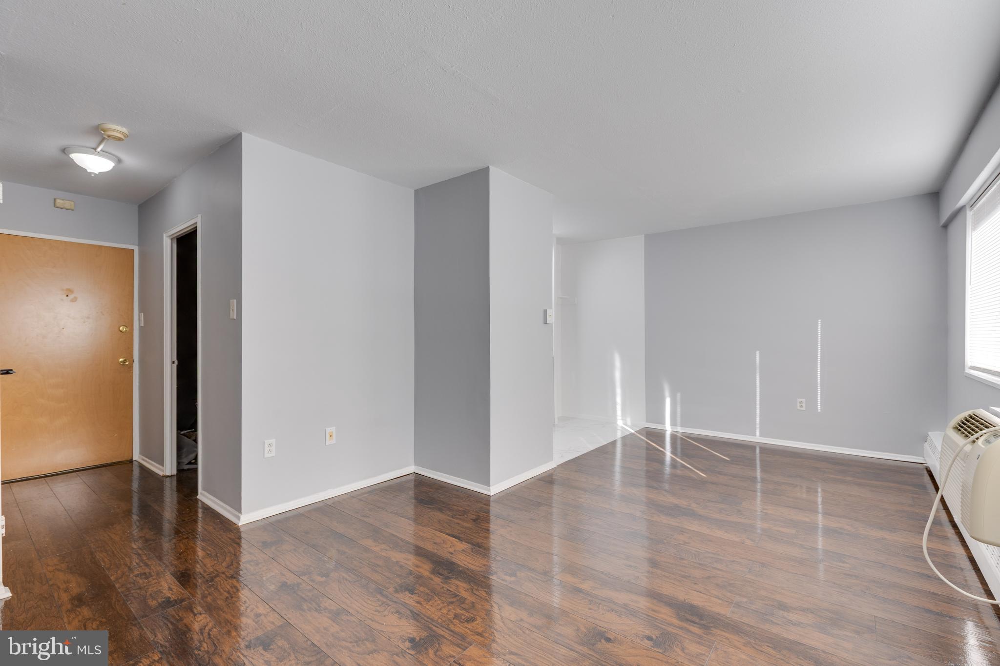 2101-17 Chestnut Street, Unit 705 Philadelphia, PA 19103 - Photo 3 of 10 wooden floor in an empty room with a window