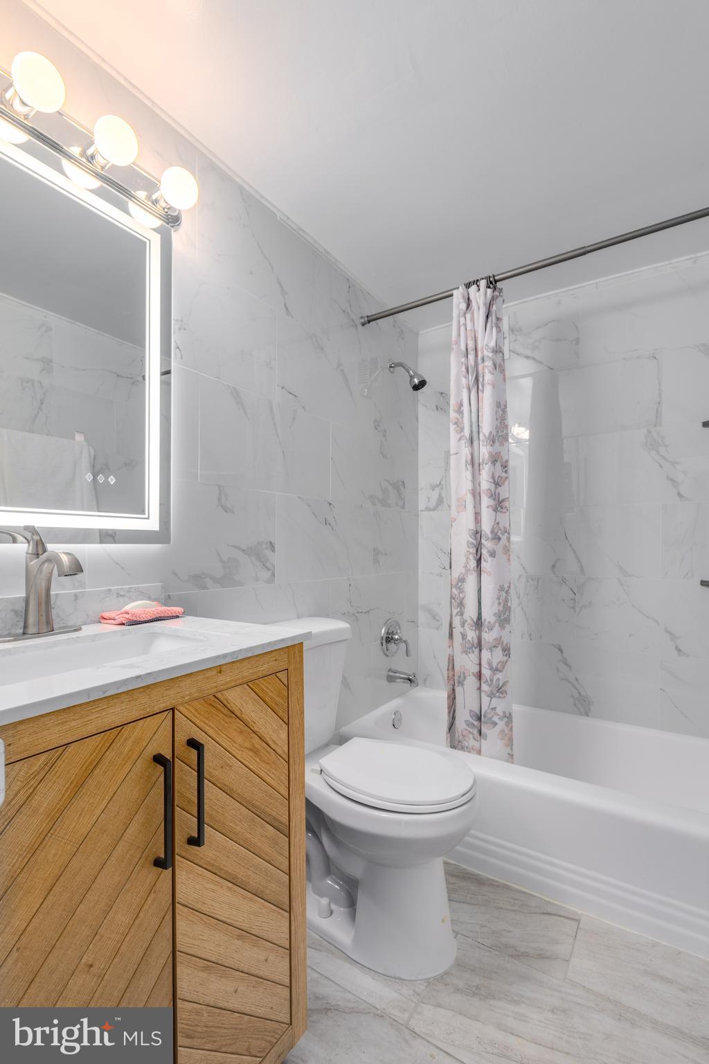 2101-17 Chestnut Street, Unit 705 Philadelphia, PA 19103 - Photo 6 of 10 a bathroom with a sink toilet and shower