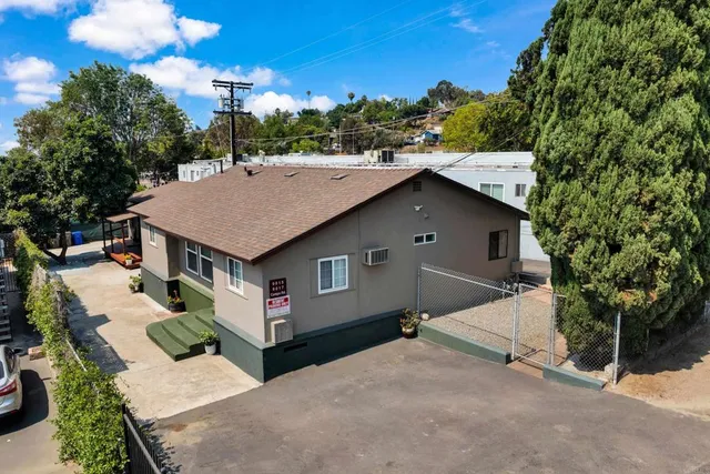 a aerial view of a house with yard and seating area