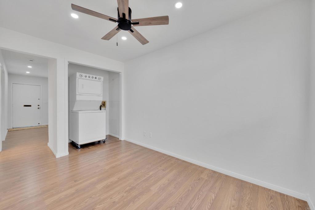 9015-9017 Campo Road Spring Valley, CA 91977 - Photo 12 of 60 an empty room with wooden floor ceiling fan and windows