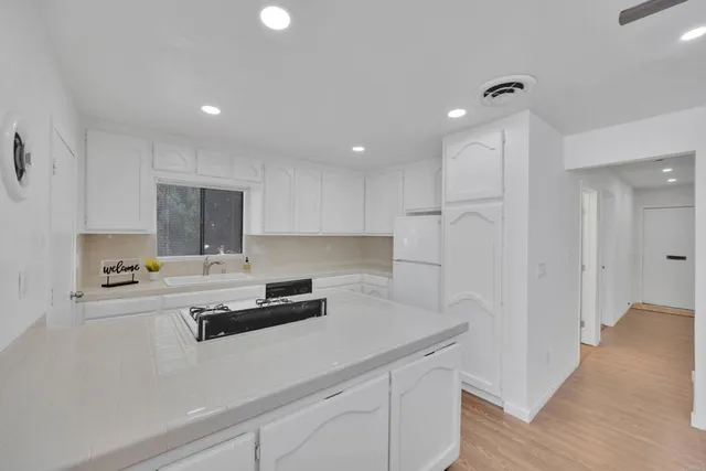 a kitchen that has a sink and a stove