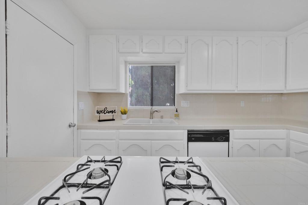 9015-9017 Campo Road Spring Valley, CA 91977 - Photo 17 of 60 a kitchen with a sink and cabinets