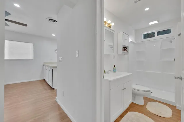 a bathroom with a sink a toilet and shower