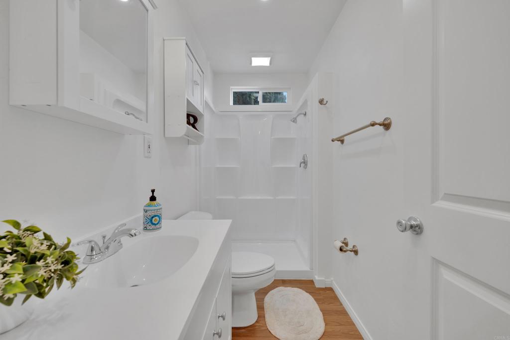 9015-9017 Campo Road Spring Valley, CA 91977 - Photo 19 of 60 a bathroom with a sink a toilet and shower