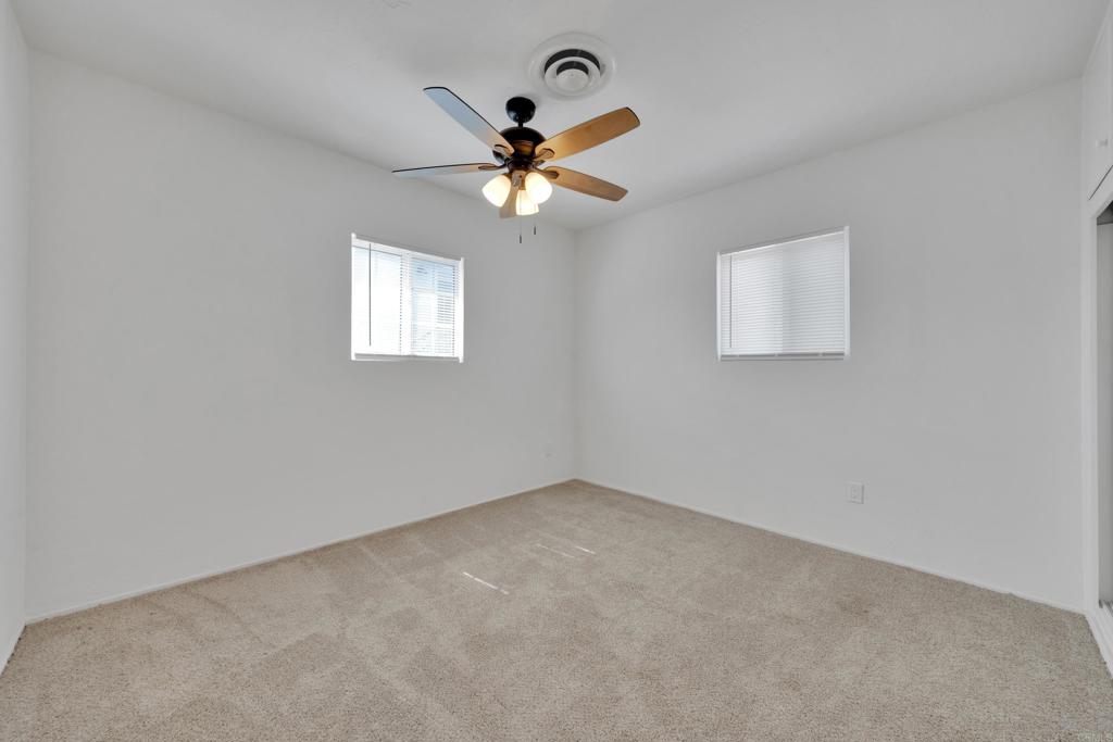 9015-9017 Campo Road Spring Valley, CA 91977 - Photo 24 of 60 an empty room with windows and fan