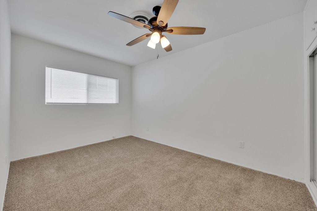 9015-9017 Campo Road Spring Valley, CA 91977 - Photo 26 of 60 an empty room with a window and a fan