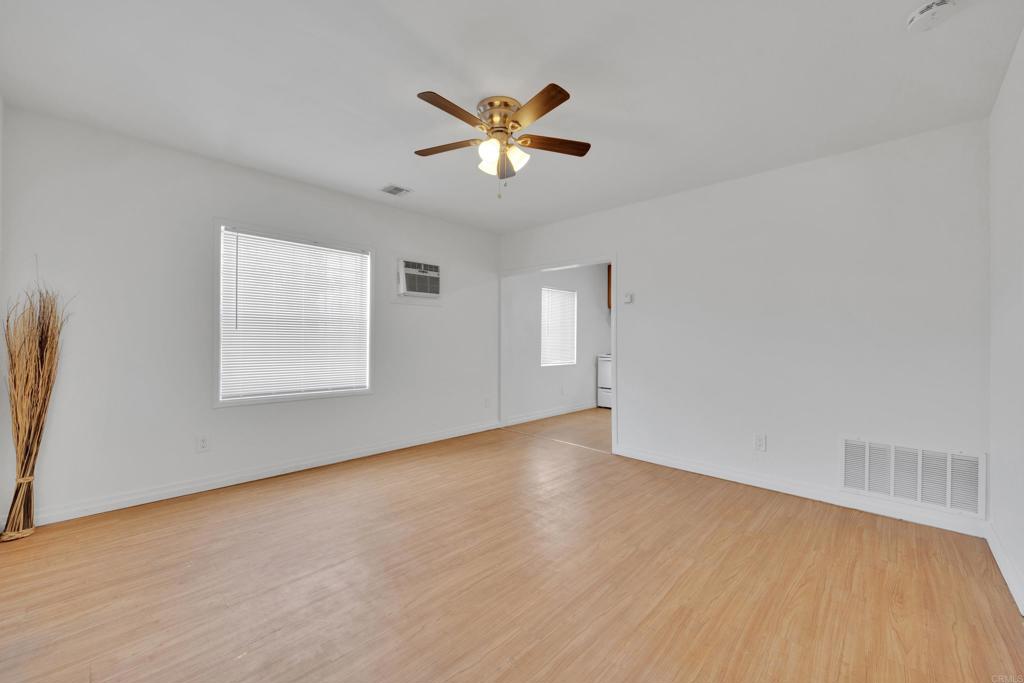 9015-9017 Campo Road Spring Valley, CA 91977 - Photo 32 of 60 a view of an empty room with wooden floor and a window