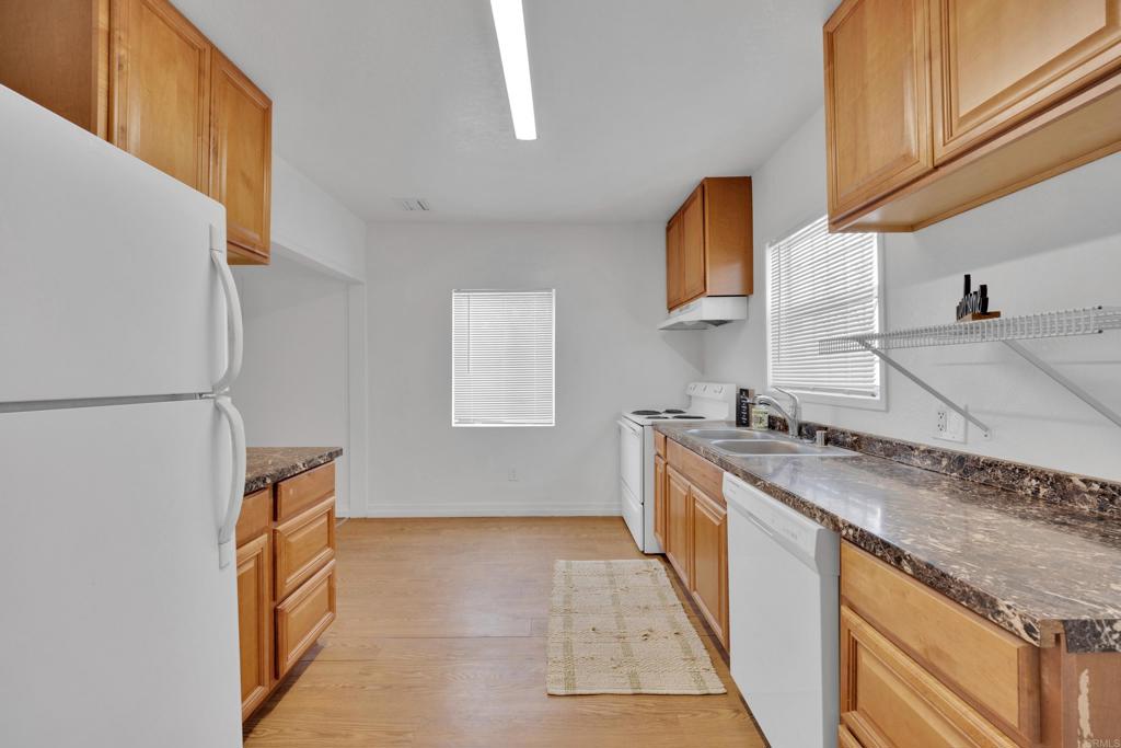 9015-9017 Campo Road Spring Valley, CA 91977 - Photo 36 of 60 a kitchen with stainless steel appliances granite countertop a sink and a stove