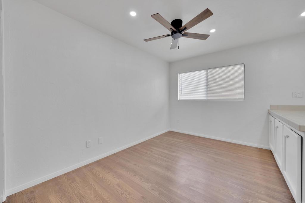 9015-9017 Campo Road Spring Valley, CA 91977 - Photo 8 of 60 an empty room with a window and a fan