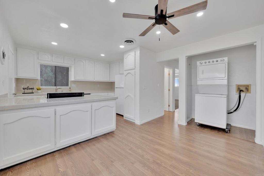 9015-9017 Campo Road Spring Valley, CA 91977 - Photo 10 of 60 a kitchen with granite countertop a refrigerator and a sink