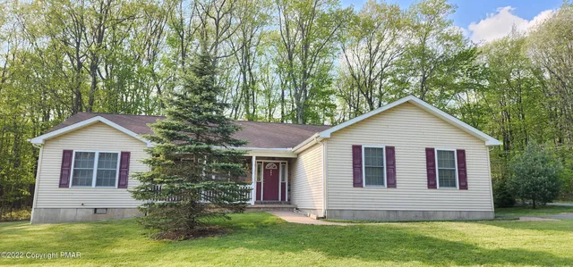 a front view of house with yard and green space