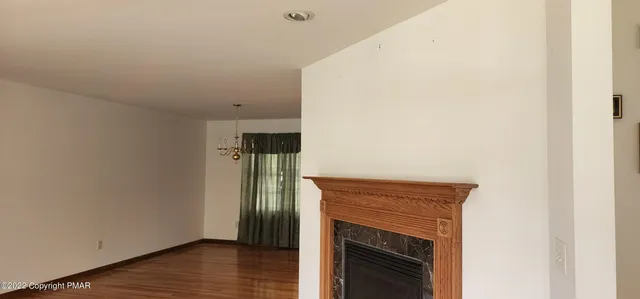 a view of hallway with wooden floor