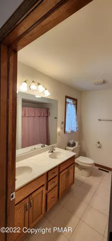 a room with a sink a stove and two windows