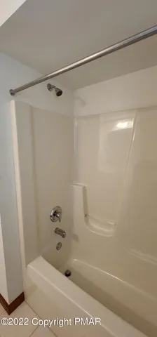 a bathroom with a shower and a bath tub