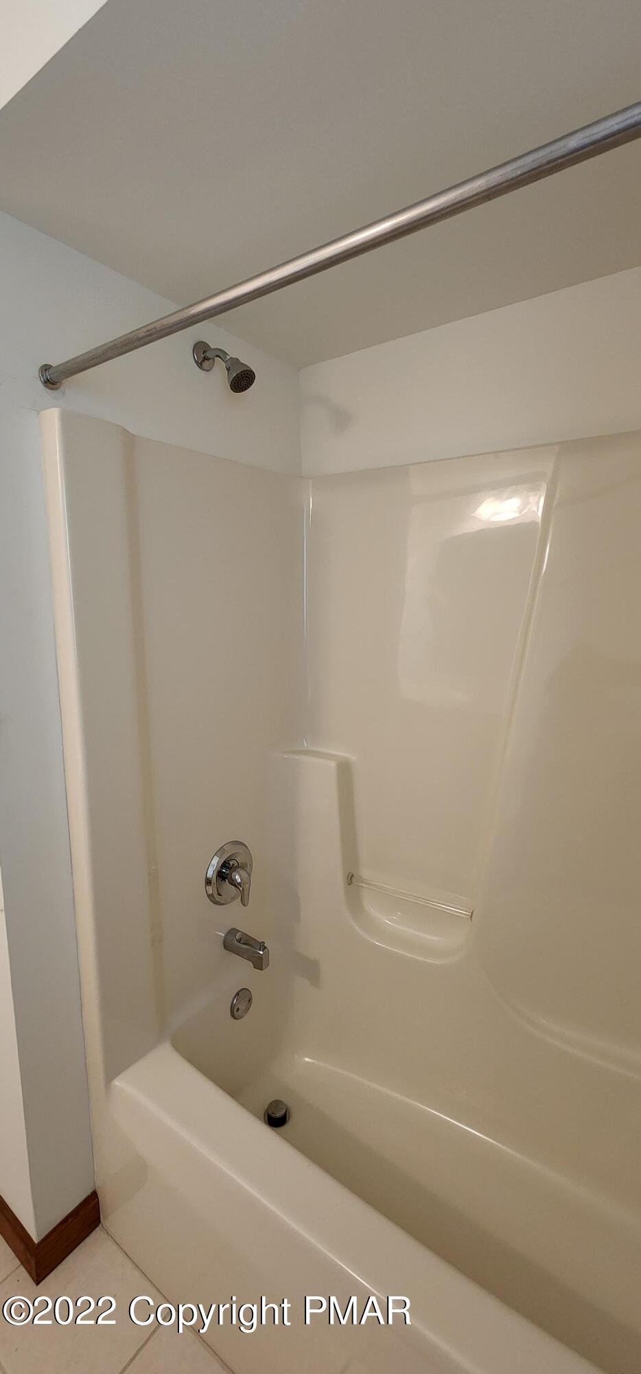 203 Sutton Place Pocono Summit, PA 18346 - Photo 15 of 22 a bathroom with a shower and a bath tub