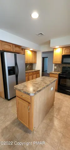 a kitchen with stainless steel appliances granite countertop a sink and a stove