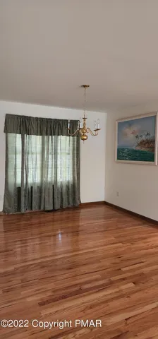 a view of a room with wooden floor
