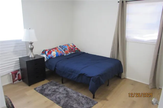 a bedroom with a bed and a window