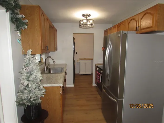 a kitchen with stainless steel appliances granite countertop a refrigerator and a stove
