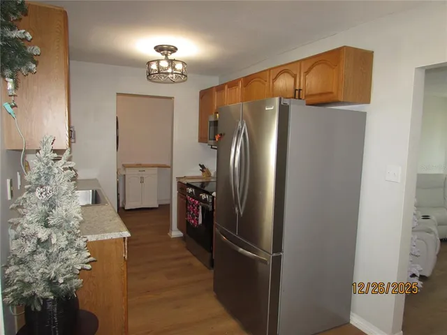 a kitchen with refrigerator and window