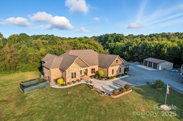 an aerial view of a house having swimming pool garden and patio