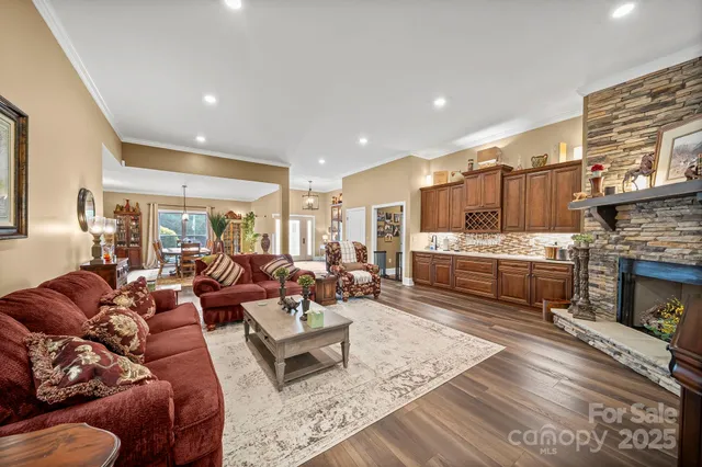 a living room with furniture wooden floor and a fireplace