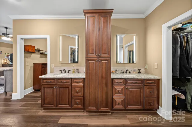 a view of hall way with furniture and wooden floor