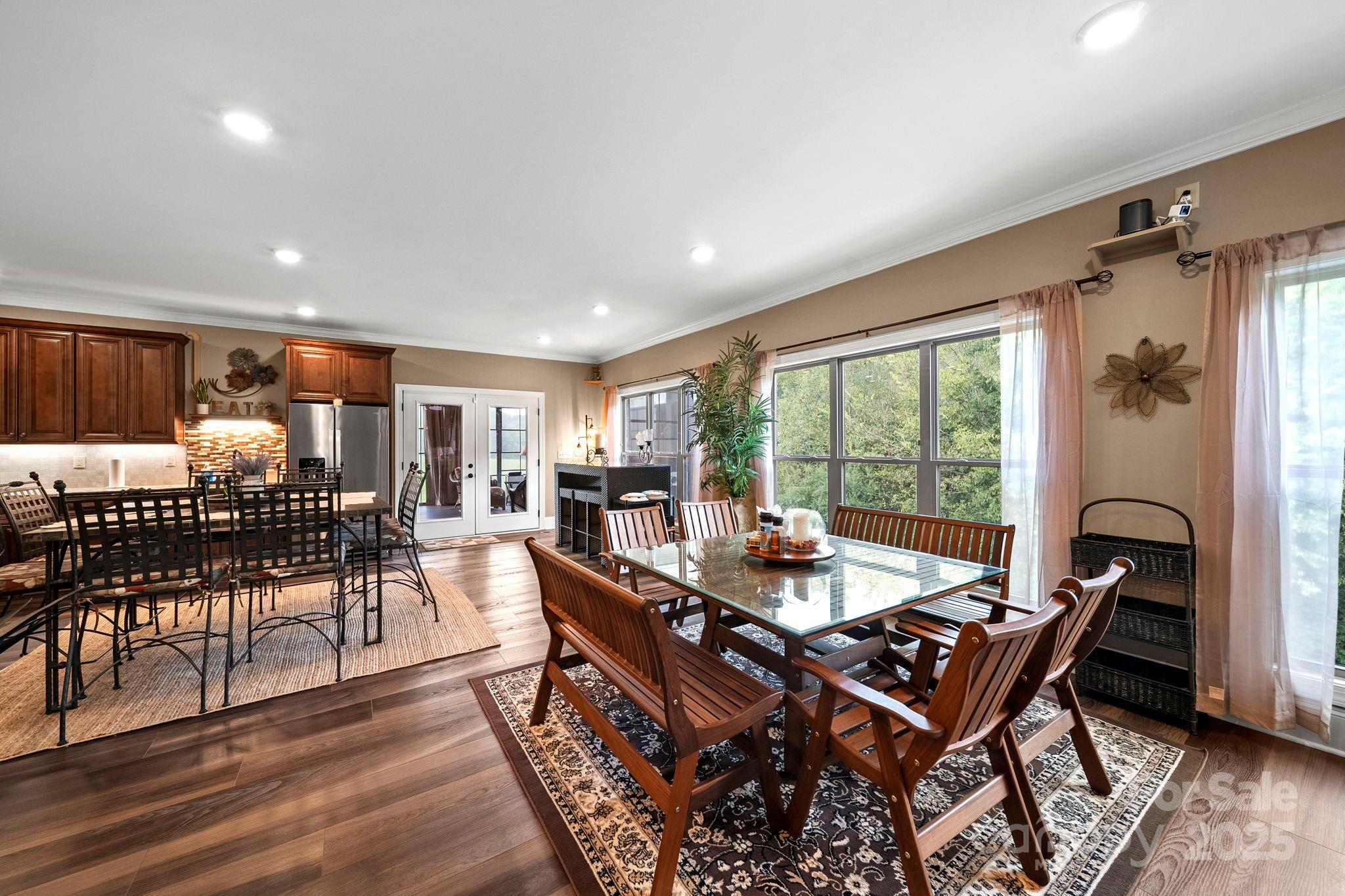 5702 Army Road Marshville, NC 28103 - Photo 23 of 48 a dining room with furniture a rug and wooden floor