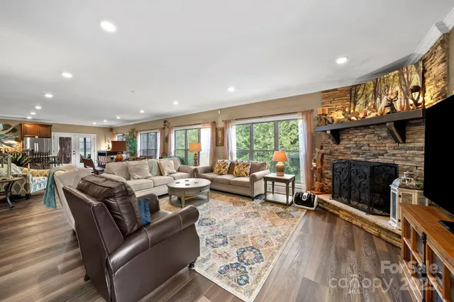 a living room with furniture large window and a fireplace