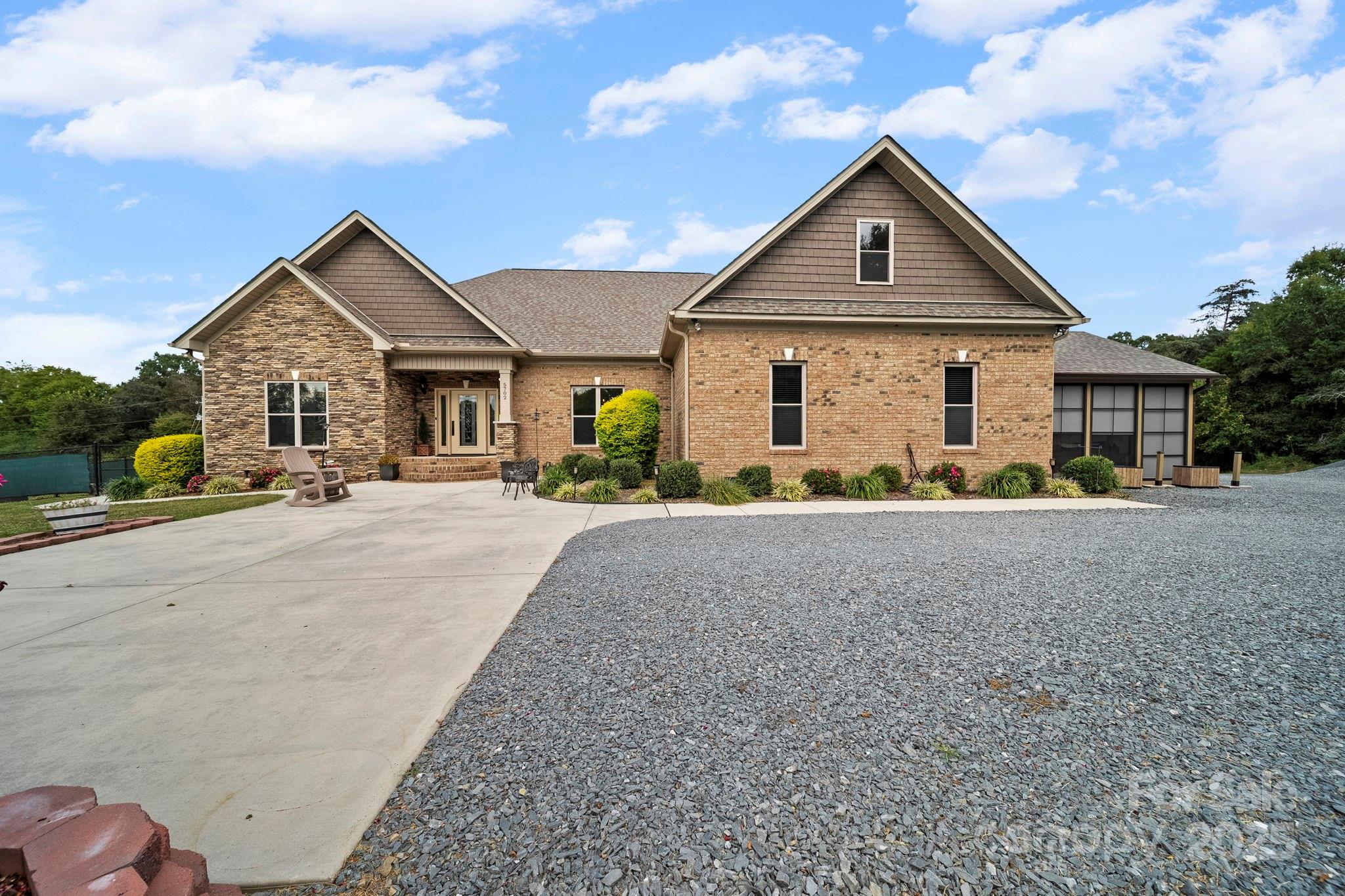 5702 Army Road Marshville, NC 28103 - Photo 3 of 48 a front view of a house with a yard and potted plants