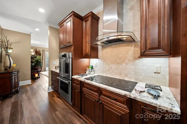 a kitchen with granite countertop a sink stove and refrigerator