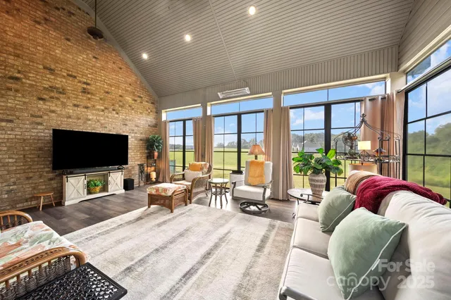 a living room with furniture tv and a large window