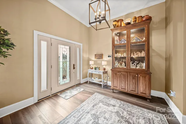 a view of a entrance and room with wooden floor