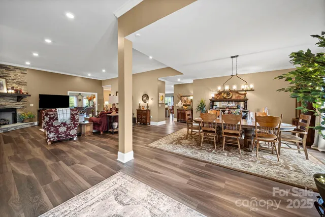 a living room with furniture dining table and a chandelier
