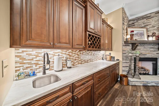 a kitchen with granite countertop a sink and a stove