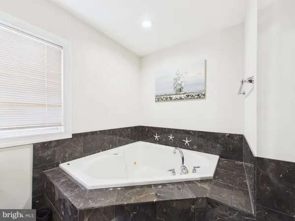 a bathroom with a bathtub and a window