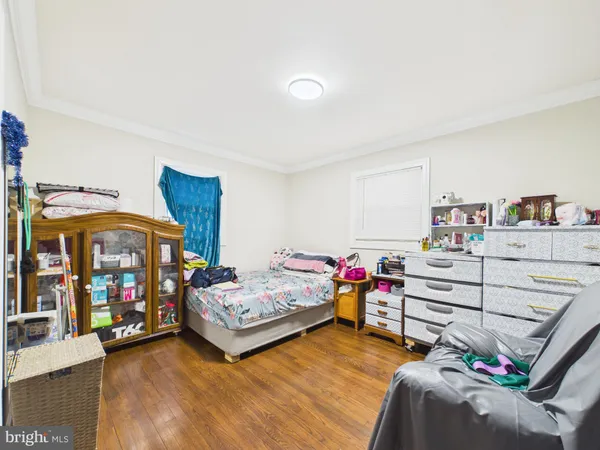 a bedroom with furniture and a baby crib